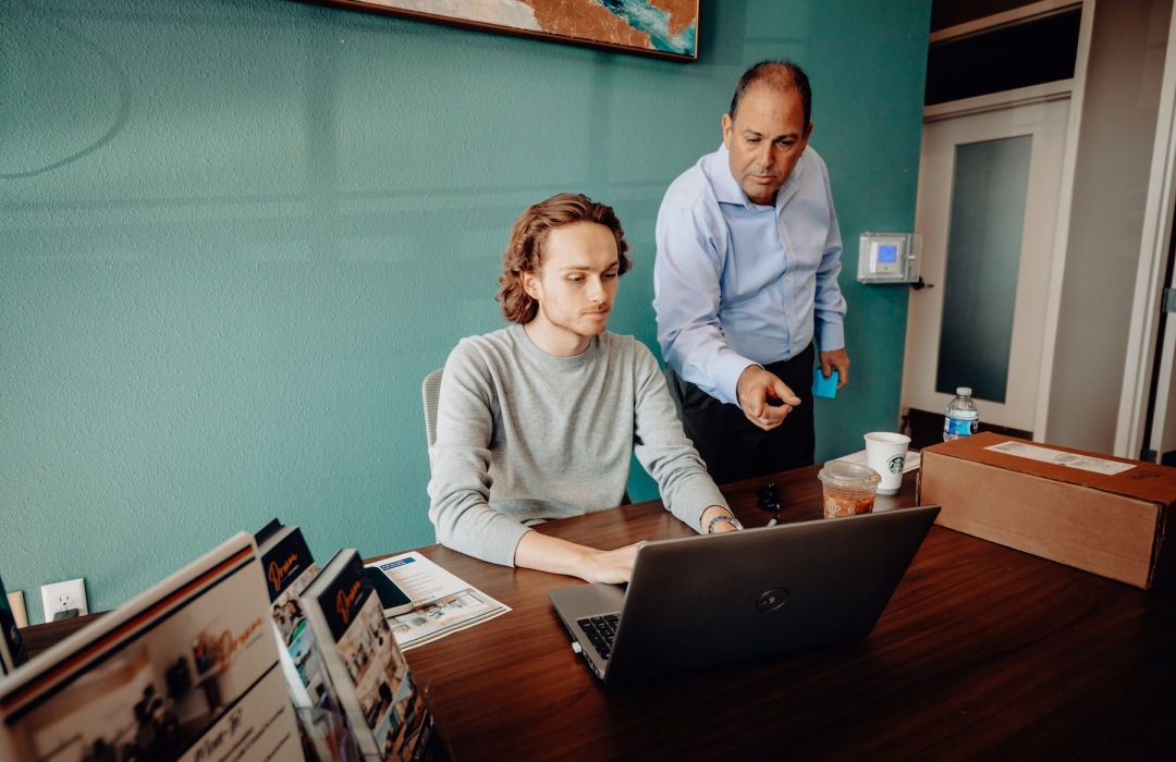 two people looking at a computer together