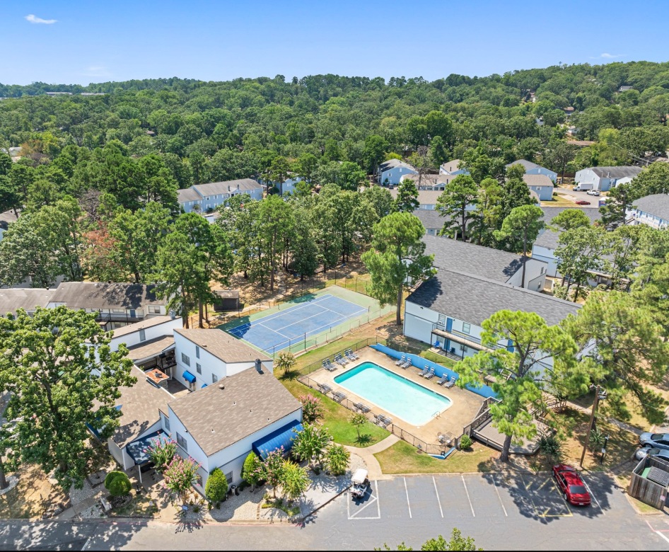 aerial view of apartments trees and pool