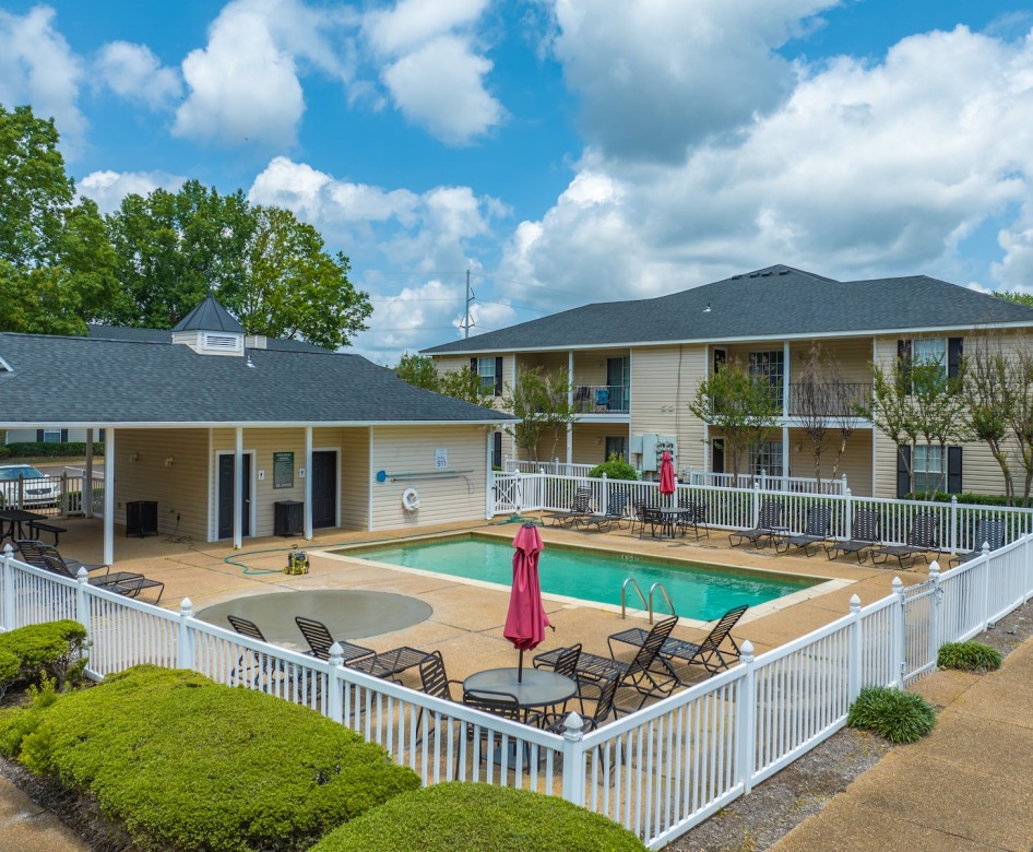 a small pool surrounded by chairs and a fance