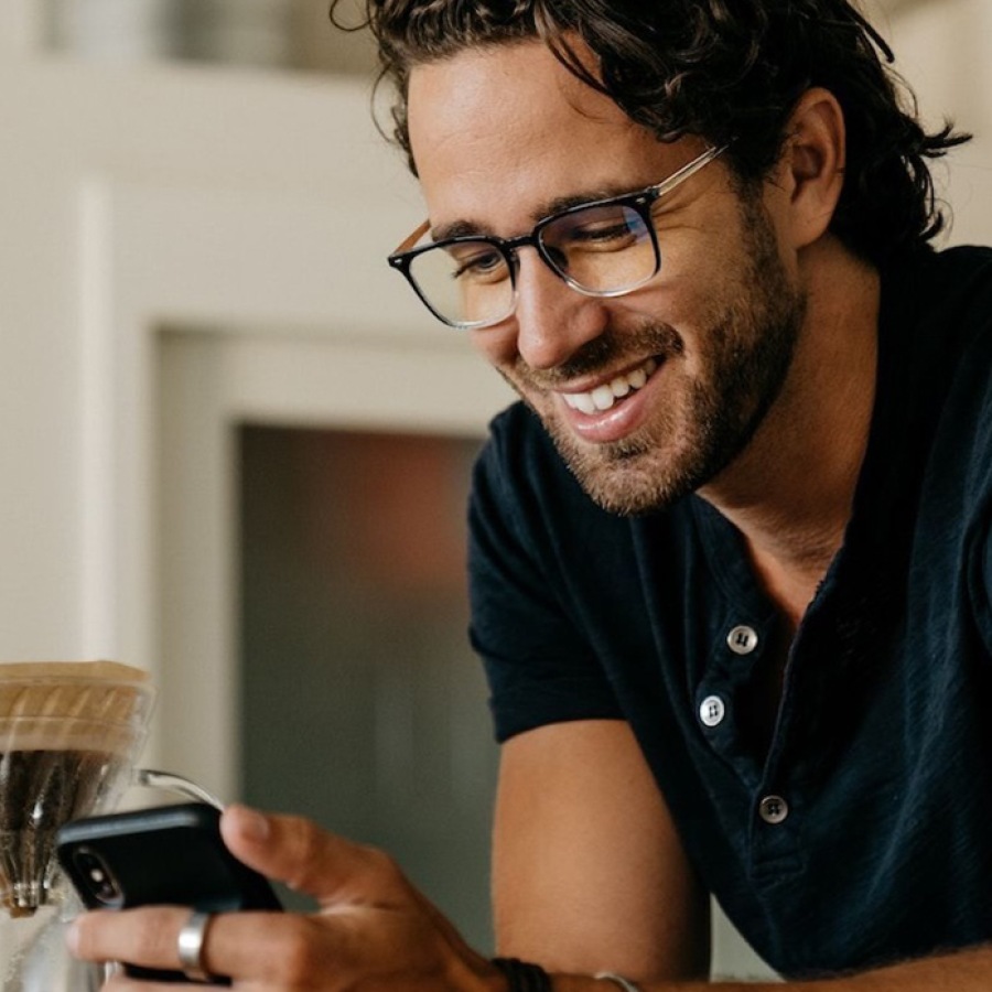 Why Choose Dream Live Prosper Commercial? a man holding a phone