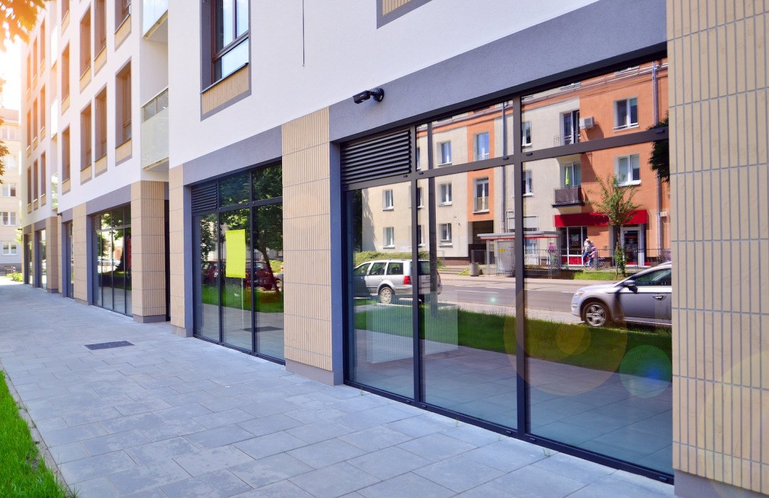 a sidewalk by retail spaces