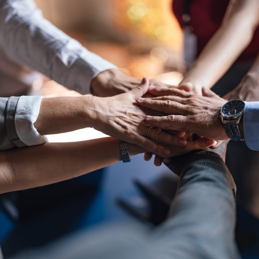 Careers with Purpose a group of people piling their hands together