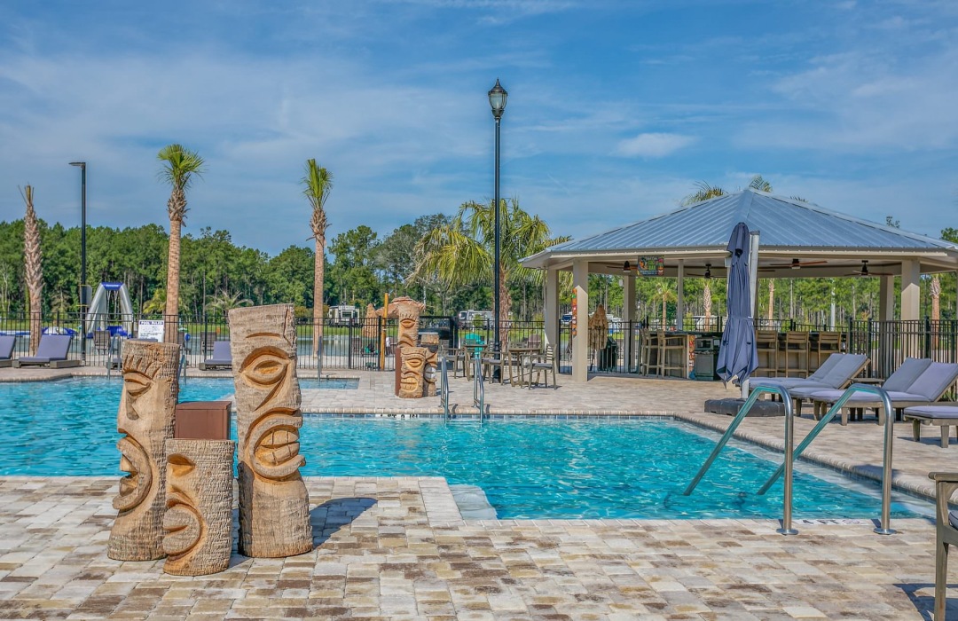 a pool with a statue beside it