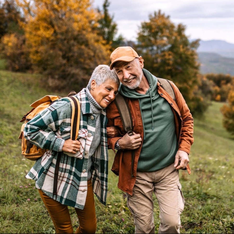 Experience the Outdoors Like Never Before a man and woman standing in a field with trees and grass